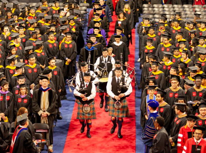Image of students and administrators at a commencement ceremony
